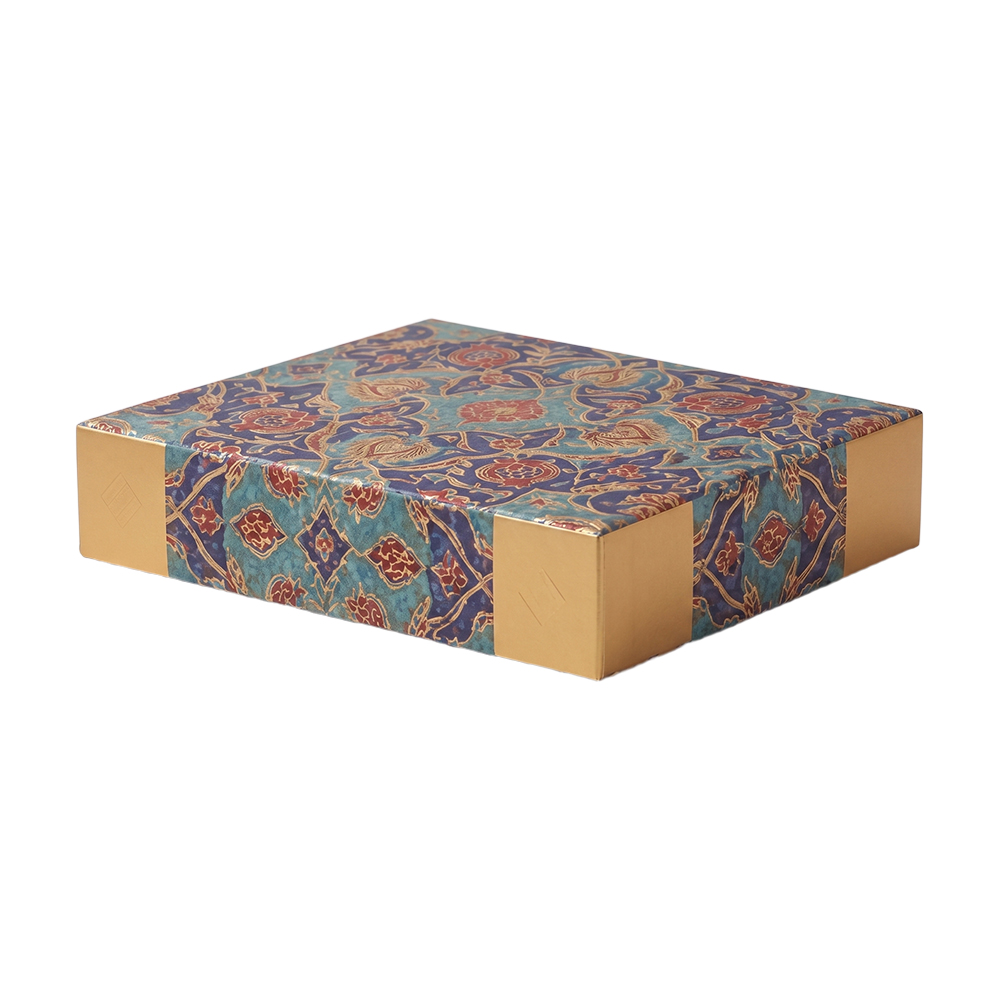 Perspective view of closed Arabesque pattern dry fruit box featuring luxury metallic gold corners.