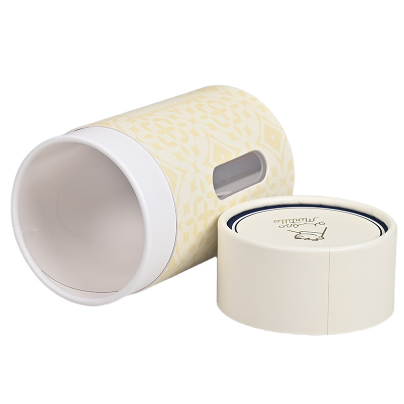 Tilted open cardboard cookie cylinder showing the transparent plastic window