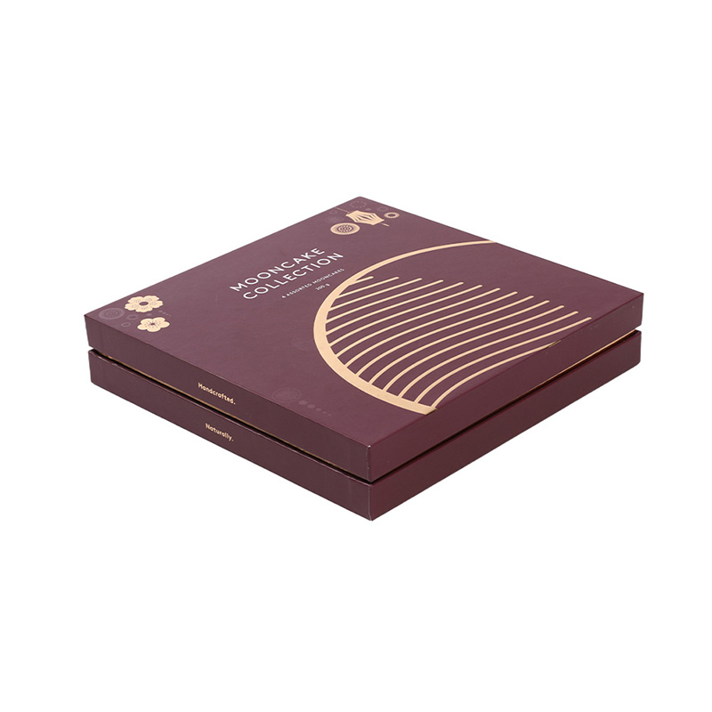 Closed deep red traditional mooncake packaging gift box with intricate gold foil design and lantern on a white background.