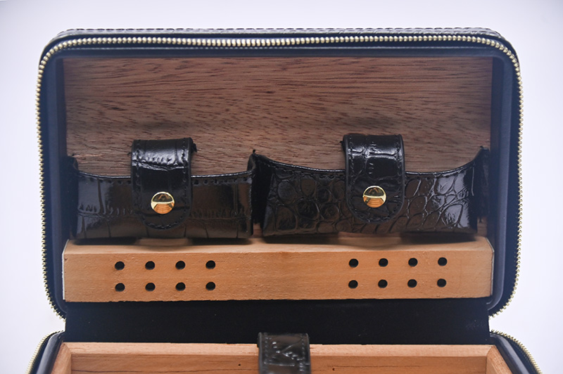 metal snaps and leather straps of leather cigar box