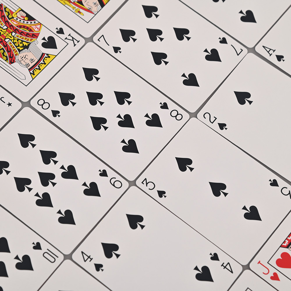 Close-up of custom printed spades and hearts on high-quality cardstock.