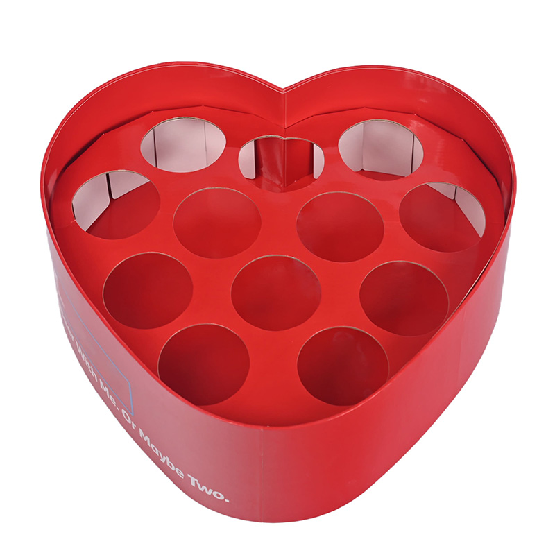 Close-up of heart-shaped box base with round hole cardboard dividers for secure gift presentation.