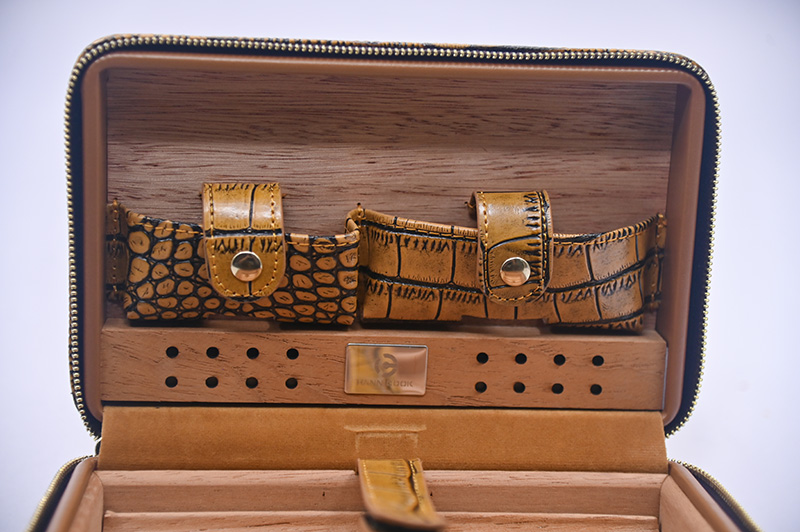 metal snaps and leather straps of leather cigar box