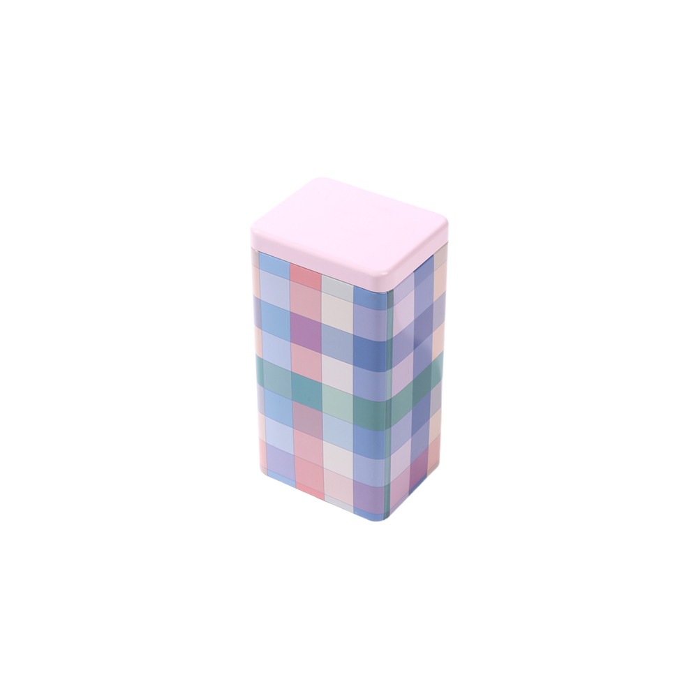 Boîte à thé décorative en métal avec des motifs minimalistes aux tons doux.