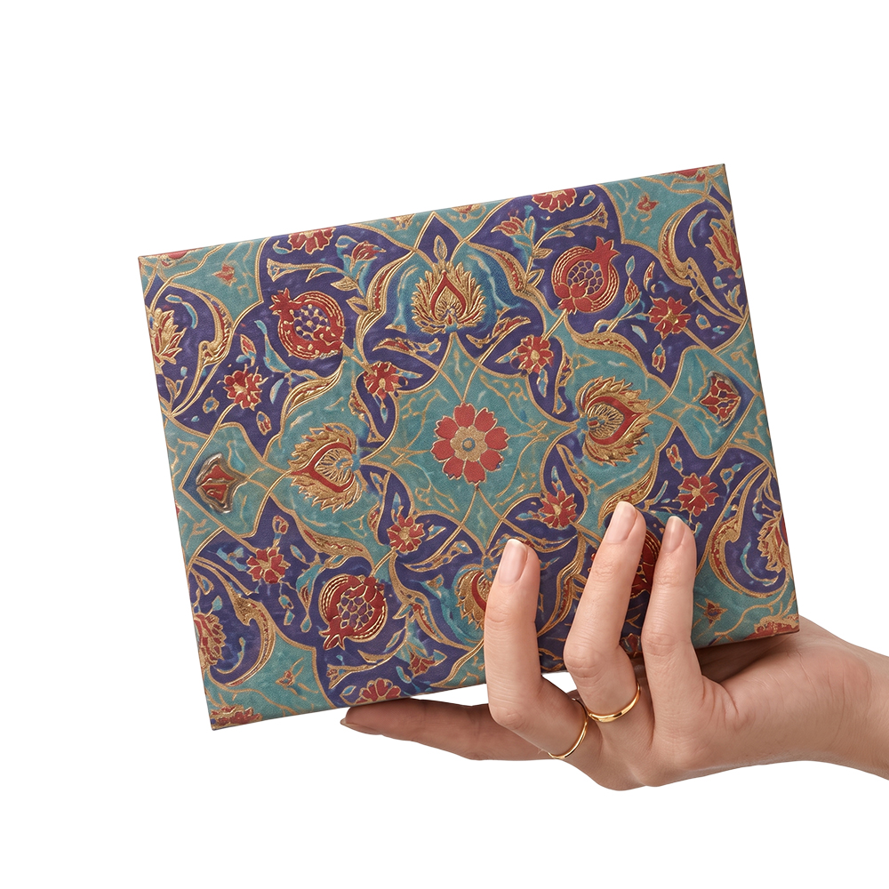 A woman's hand holding a custom printed Middle Eastern style rigid gift box for size reference.