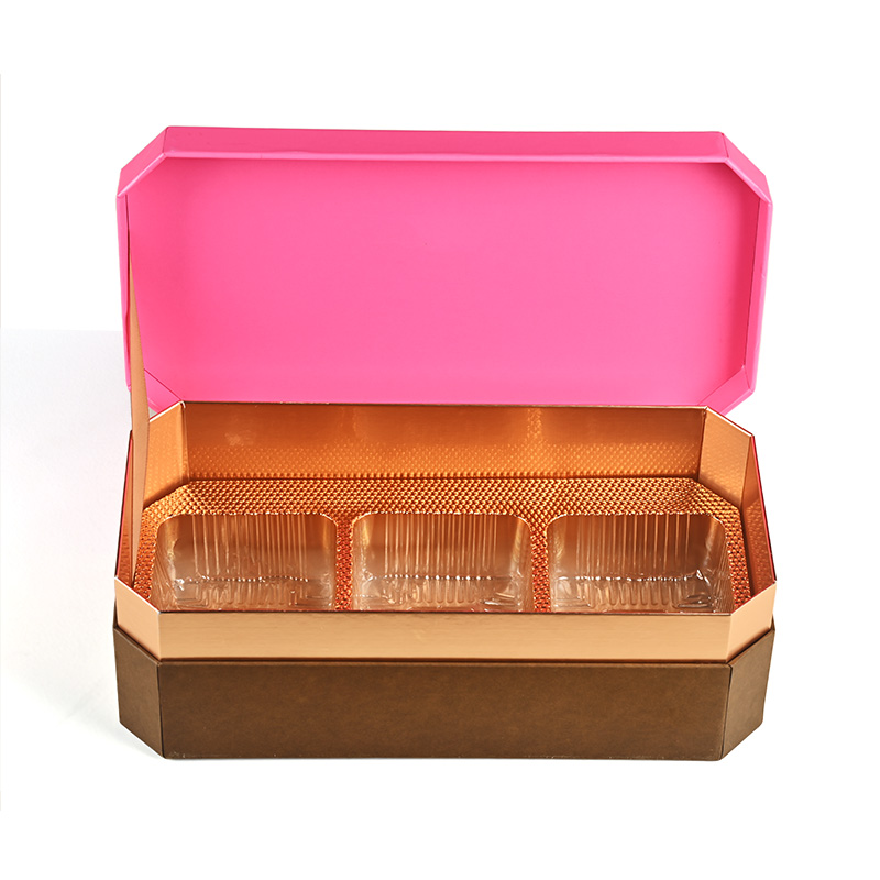 Vorder ansicht einer offenen Mooncake-Geschenk box mit einer schützenden Blister schale aus goldenem Kunststoff mit drei quadratischen Fächern.