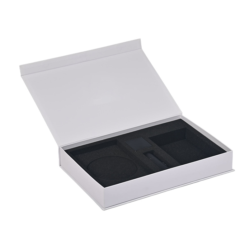 Opened custom white magnetic gift box with black die-cut foam insert