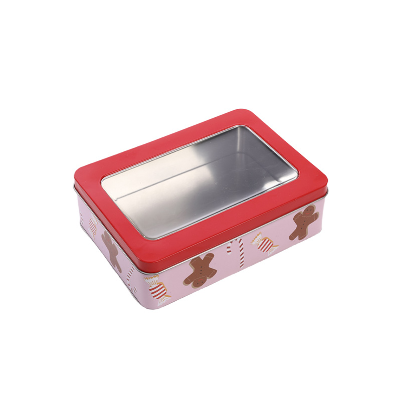 angle view of a pink rectangular Christmas tin cookie box with red transparent window lid