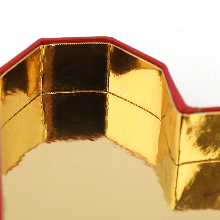 Close-up of precise edges and gold lining inside rigid heart packaging