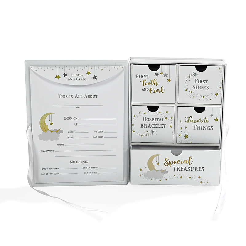Interior details of newborn keepsake organizer including photo card envelope and five mini drawers.
