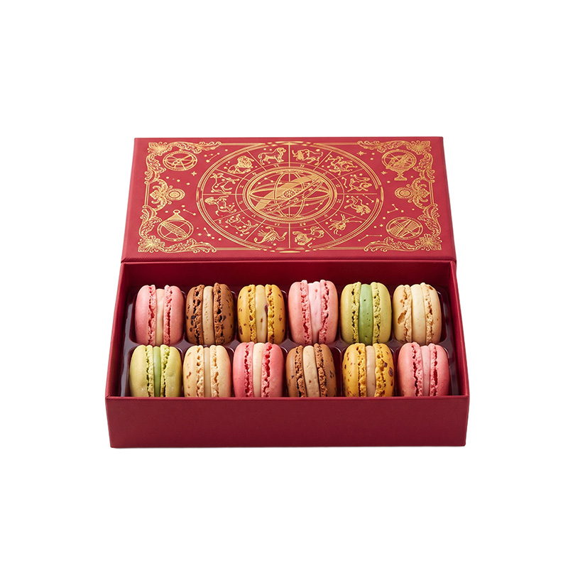 Top view of 12 assorted colorful macarons neatly arranged in a luxurious red packaging box.