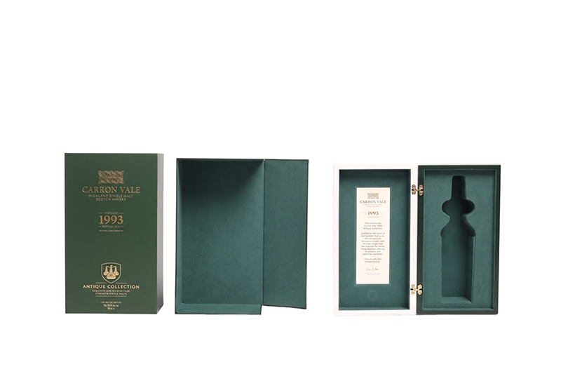 Open customized wood wine storage box revealing premium green suede lining molded for a specific bottle.