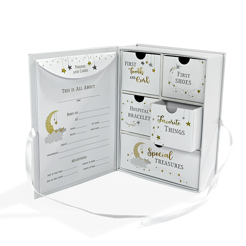 Open book-style baby keepsake box displaying customizable newborn milestone fill-in page.