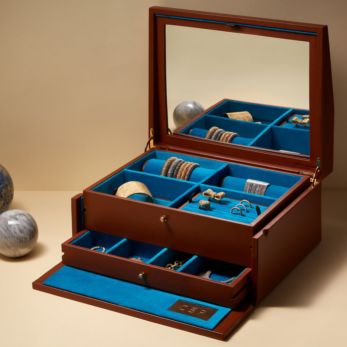 The image shows an open, multi - layer wooden jewelry box with rich brown wood exterior and blue velvet interior. The top lid has a built - in mirror.