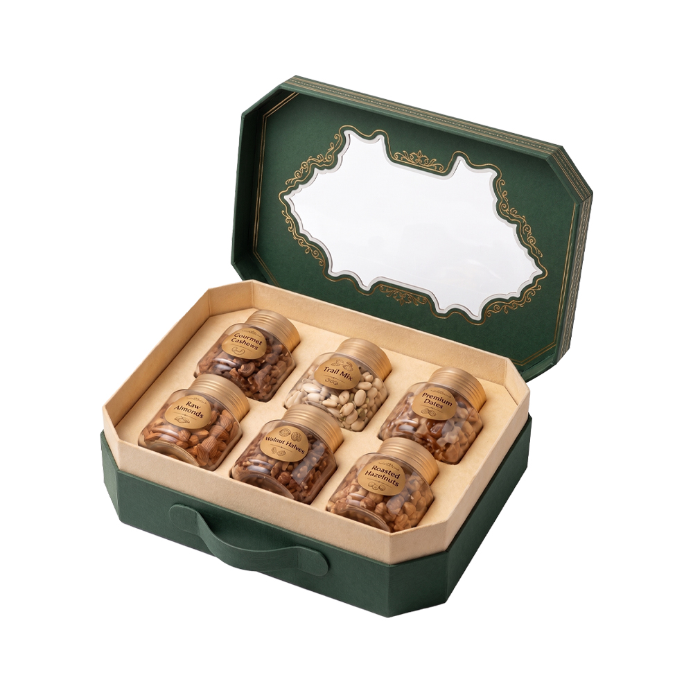 Opened suitcase-style gift box revealing six jars of premium dry fruits inside.
