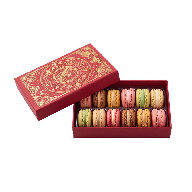 Open luxurious red macaron box revealing 12 colorful macarons inside a plastic blister tray.