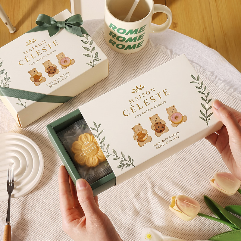 Hand opening a drawer-style cookie packaging box.