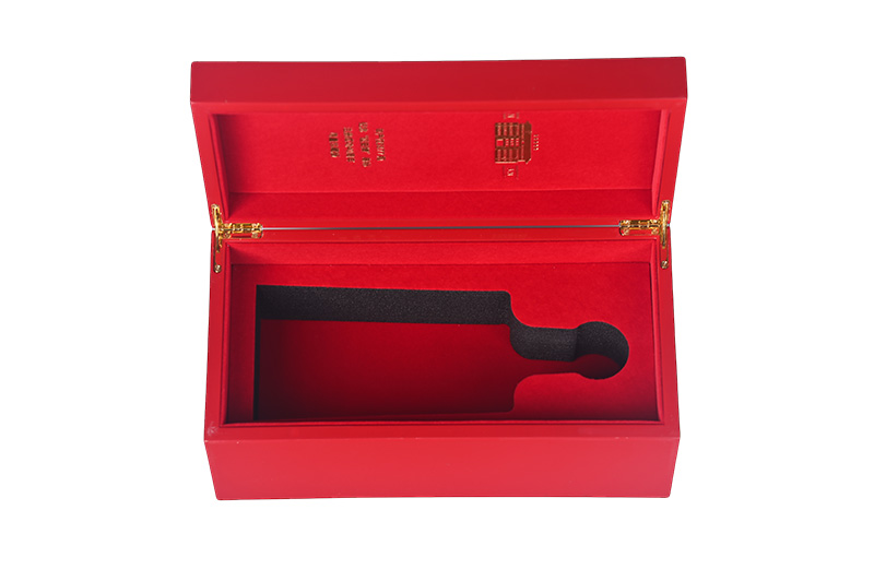 Top-down view of empty red piano varnish wooden wine box with bespoke bottle housing