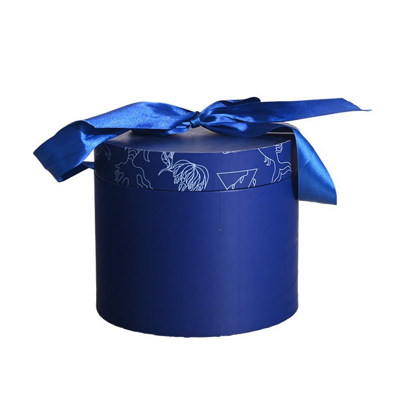Front view of a closed dark blue cylindrical custom cake box with a satin ribbon bow by Brothersbox.