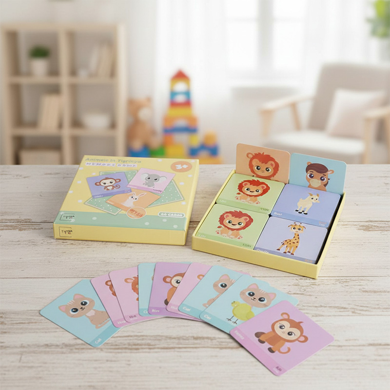 Kids memory card game placed on a wooden table in a bright nursery room setting.
