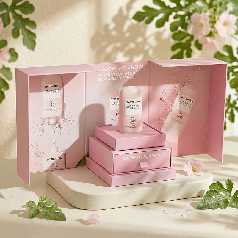 Lifestyle scene of creative pink double-door sunscreen gift box displayed with plants and water drops